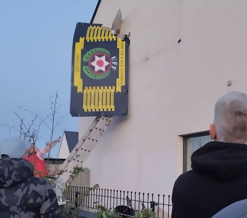 A number of men arrived at the Weavers Grange area of Newtownards with ladders to remove signs and poster from building which supports the UFF.