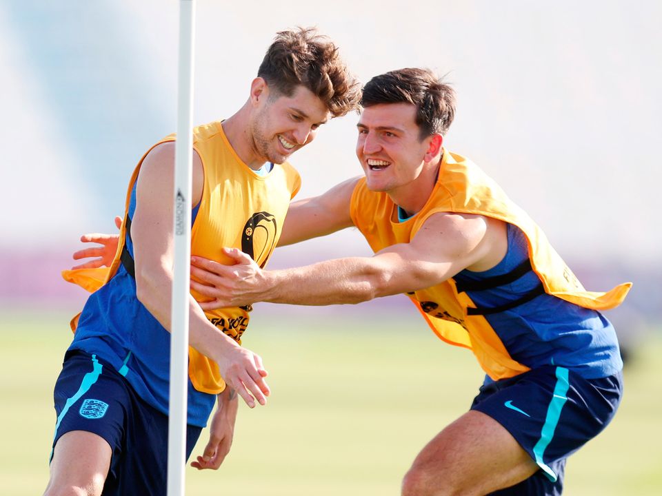 DOHA, QATAR - NOVEMBER 24: John Stones (L) and Harry Maguire of England train during the England Training Session at Al Wakrah SC Stadium on November 24, 2022 in Doha, Qatar. (Photo by Alex Pantling/Getty Images)
