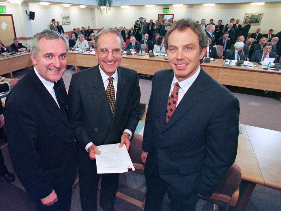 Former Taoiseach Bertie Ahern, US Senator George Mitchell (centre) and former British Prime Minister Tony Blair (r) smiling after they signed the Good Friday Agreement. Photo: PA