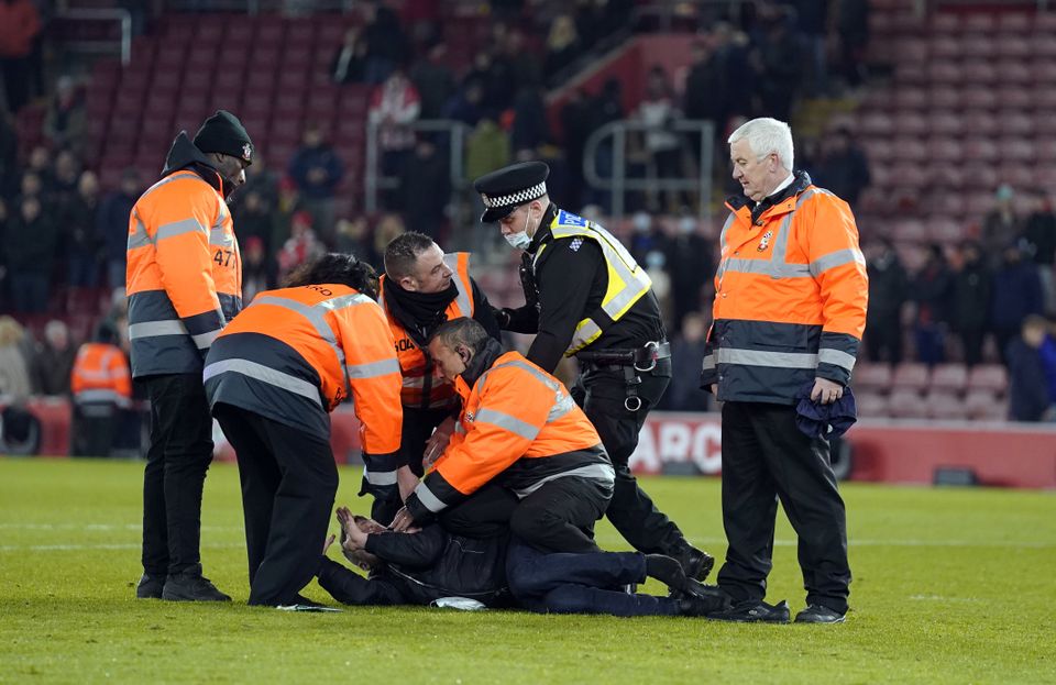 A pitch invader is stopped in his tracks (Andrew Matthews/PA)