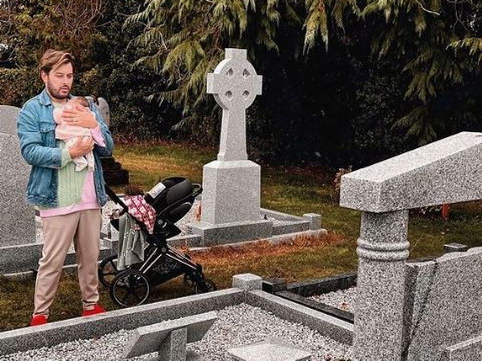 Brian Dowling at the grave of his mother with baby Blake