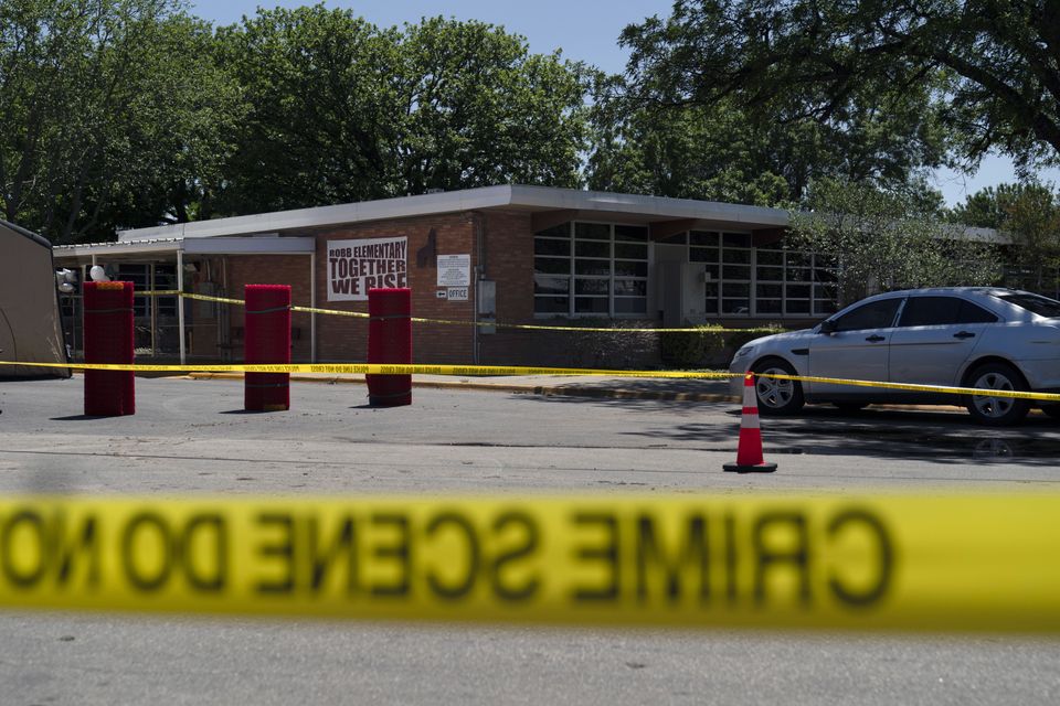 Crime scene tape surrounds Robb Elementary School in the wake of the shooting (Jae C Hong/AP)