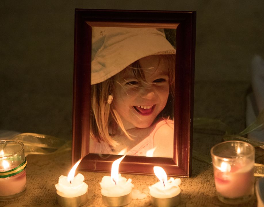 Candles next to a photo of Madeleine McCann inside the Church of Nossa Senhora da Luz in Praia da Luz (Steve Parsons/PA)