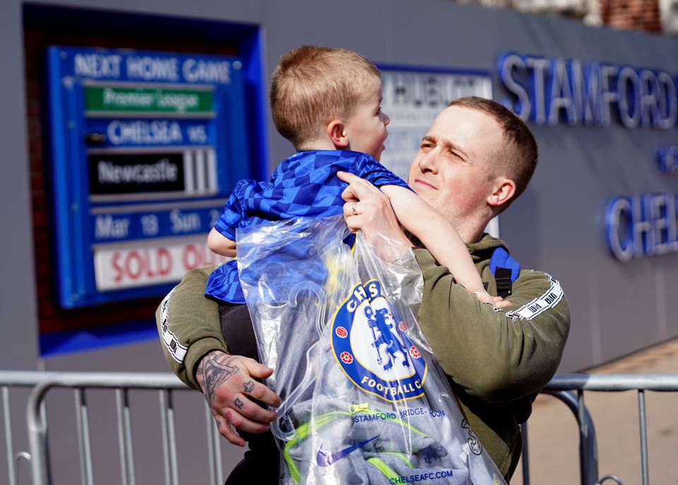 Martyn Hardiman with his son Peter, two, after purchasing the last Chelsea shirt before the store at Stamford Bridge closed on Thursday (Stefan Rousseau/PA)