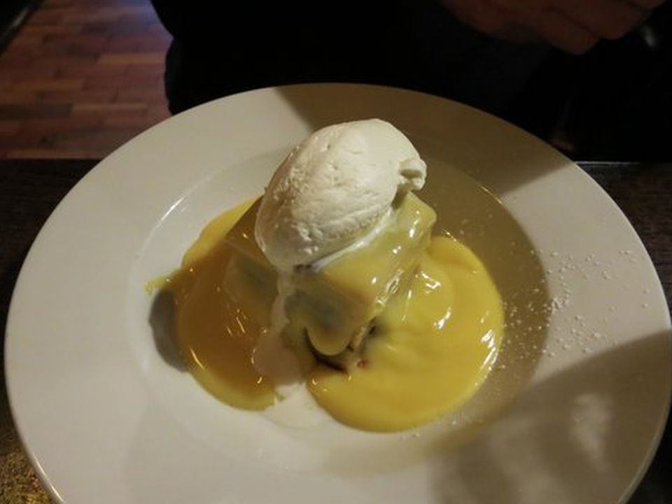 Custard-covered bread and butter pudding