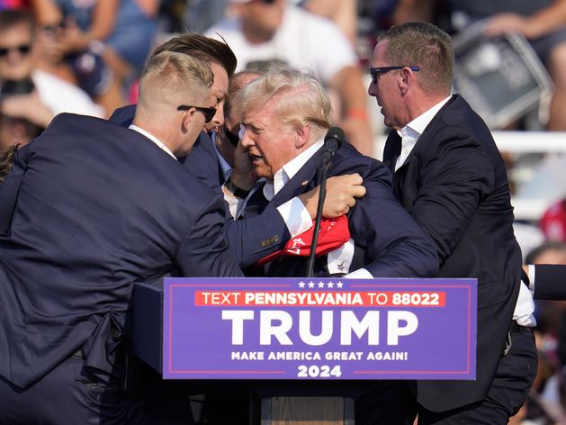 Donald Trump left bloodied after shots fired at US rally