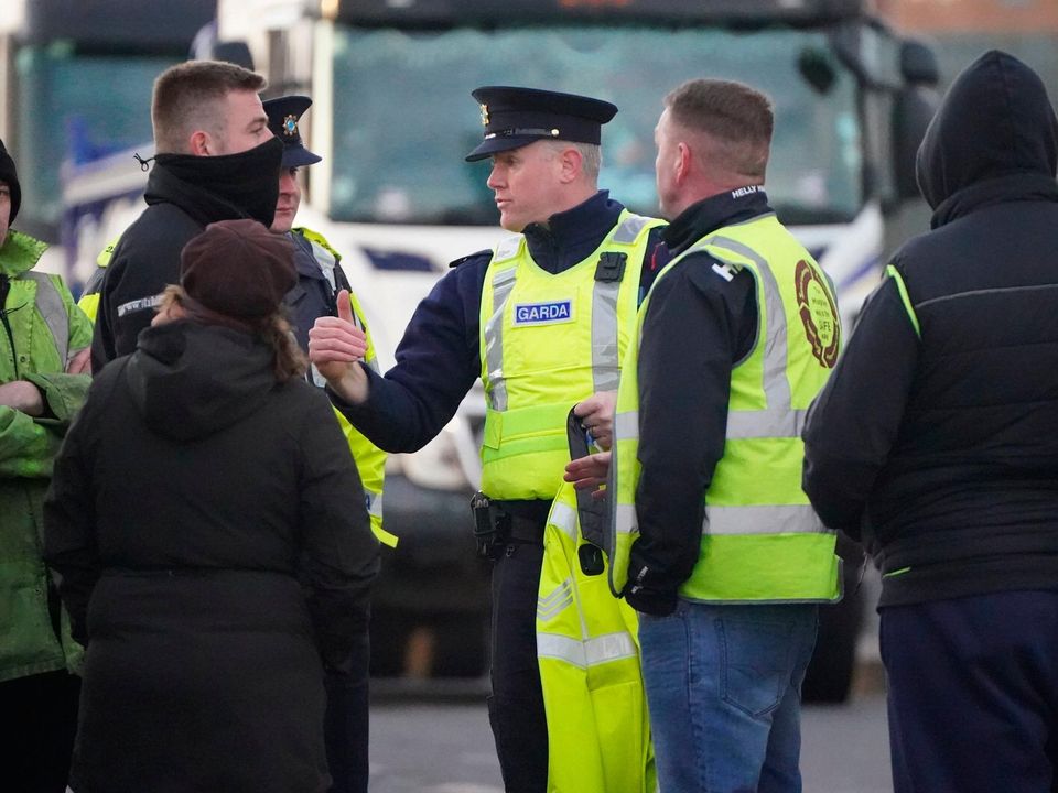 Gardaí talk to hauliers and truckers on Dublin's East Link Toll bridge on Monday morning. Picture: PA