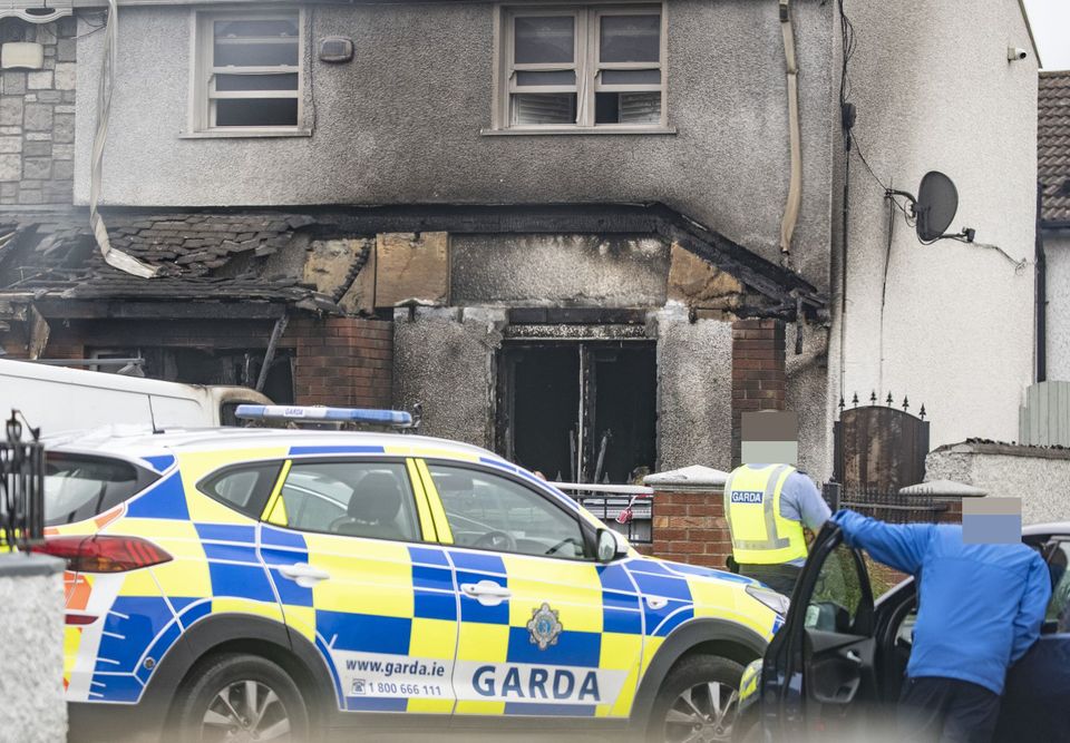 Police at the scene of the burnt-out home of James Whelan’s mother, Sonya