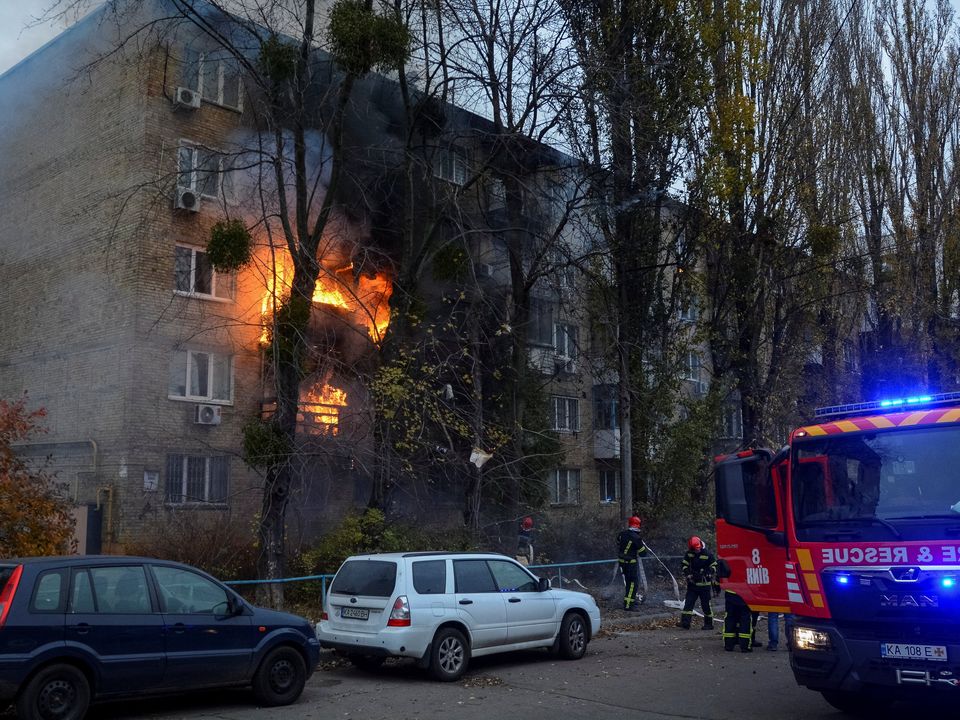 Firefighters at a fire in a residential building hit by a Russian missile in Kyiv, Ukraine. Photo: Reuters/Oleksandr Gusev