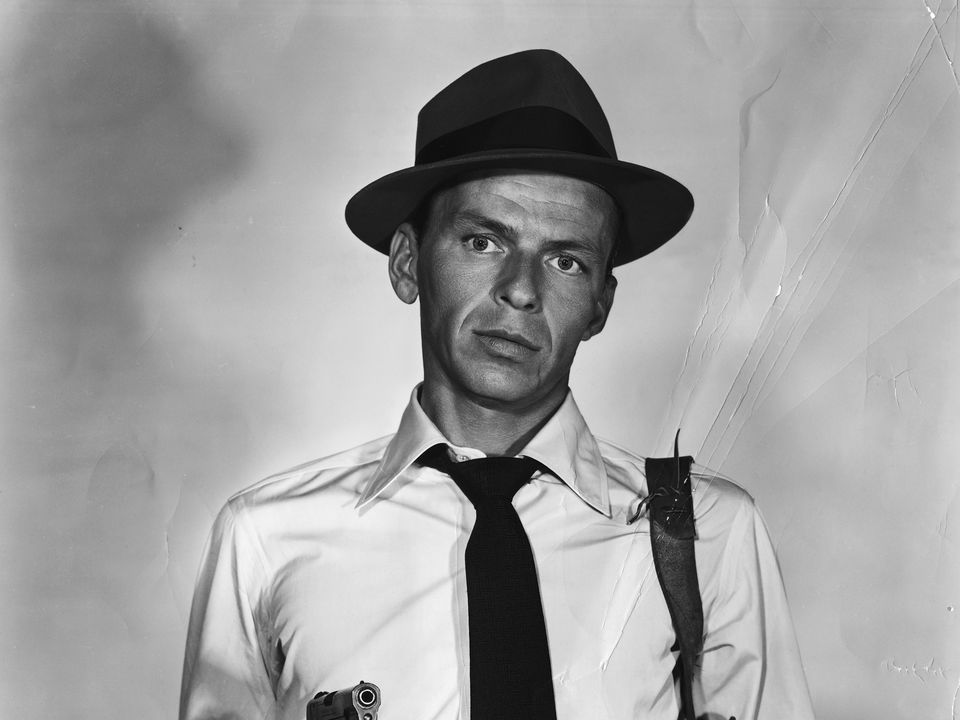 Publicity Photo of Frank Sinatra holding a gun as John Baron in the 1954 film Suddenly.
