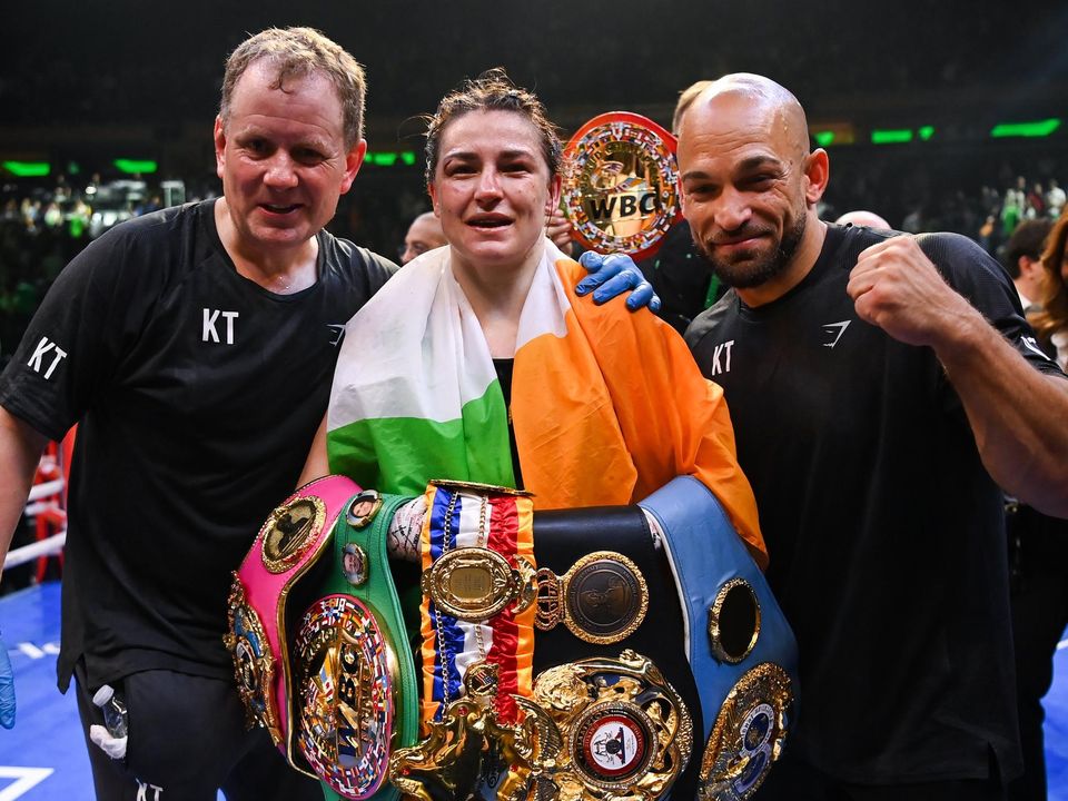 Katie Taylor with her manager Brian Peters (left) and her trainer Ross Enamait (right). Image credit: Sportsfile.