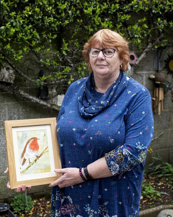 Breda Parle Breslin poses with one of her paintings at her home in Carrick-on-Suir