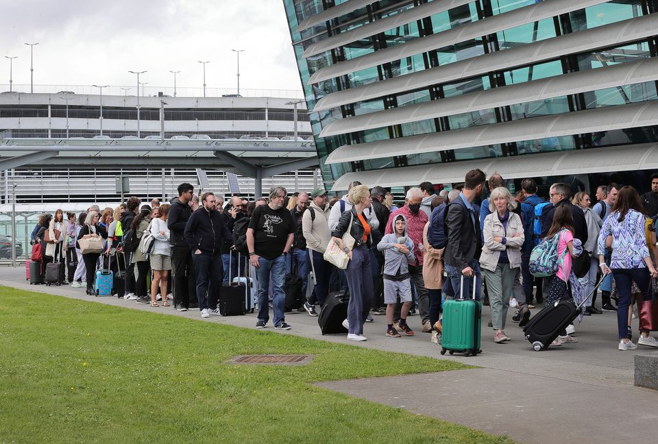 Passengers form long queues at Dublin Airport. Photo: Frank McGrath