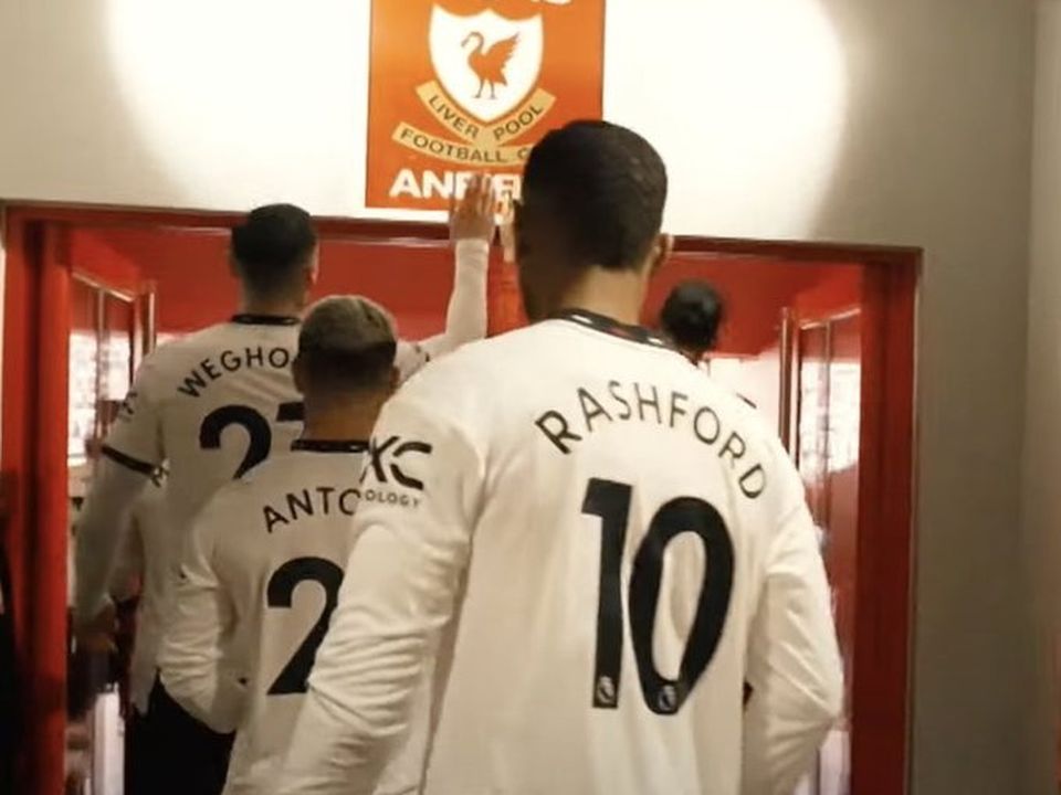 Weghorst touches the Anfield sign