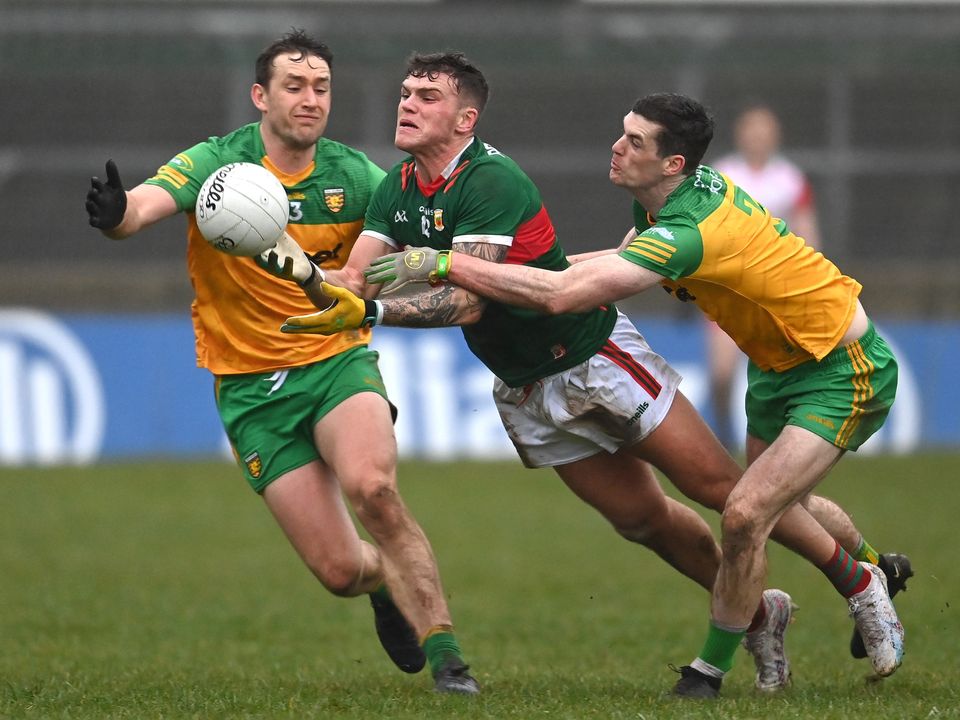 Jordan Flynn of Mayo in action against Hugh McFadden, left, and Caolan Ward of Donegal in a dour game in Ballybofey. Photo: Ramsey Cardy/Sportsfile