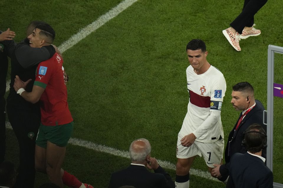 Portugal's Cristiano Ronaldo, right, reacts as he walks off the field after their loss in the World Cup quarterfinal soccer match against Morocco, at Al Thumama Stadium in Doha, Qatar, Saturday, Dec. 10, 2022. (AP Photo/Alessandra Tarantino)