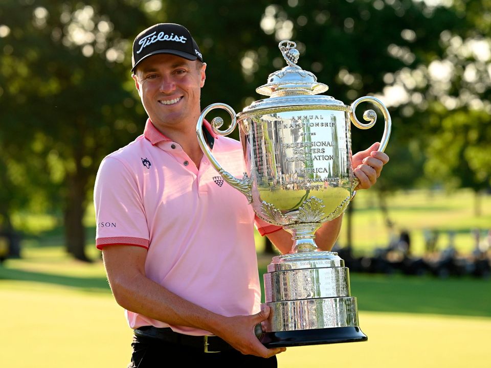 Justin Thomas of the USA celebrates with the Wanamaker Trophy. Photo: Ross Kinnaird/Getty