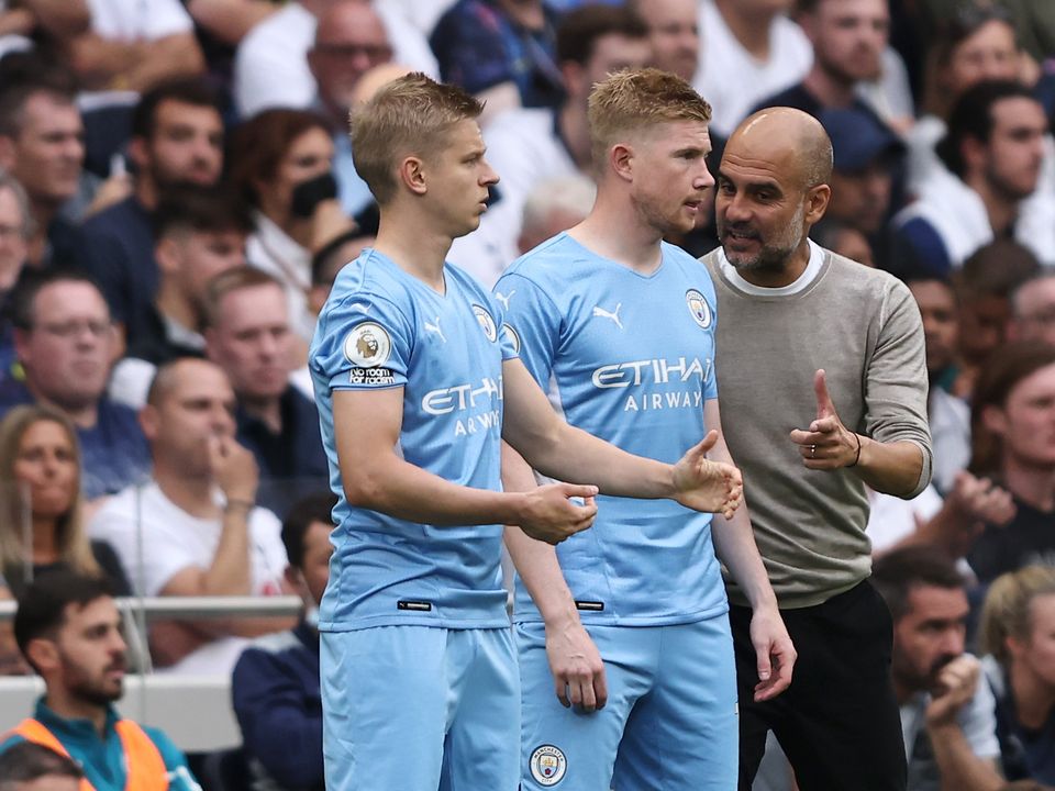 Oleg Zinchenko (left) with Kevin de Bruyne and Pep Guardiola (right).