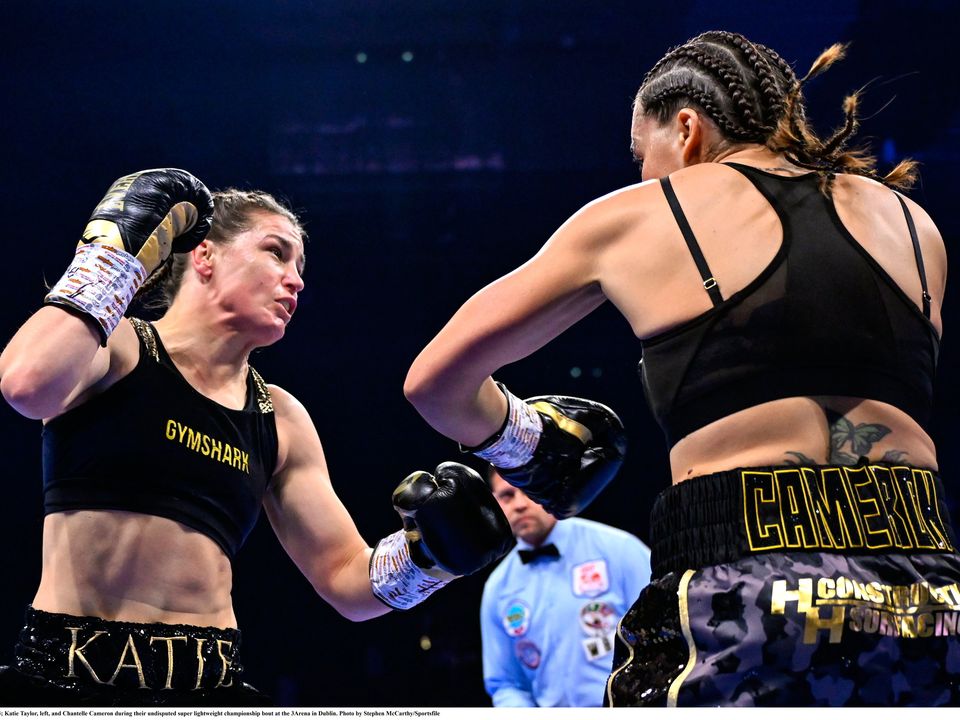 25 November 2023; Katie Taylor, left, and Chantelle Cameron during their undisputed super lightweight championship bout at the 3Arena in Dublin. Photo by Stephen McCarthy/Sportsfile