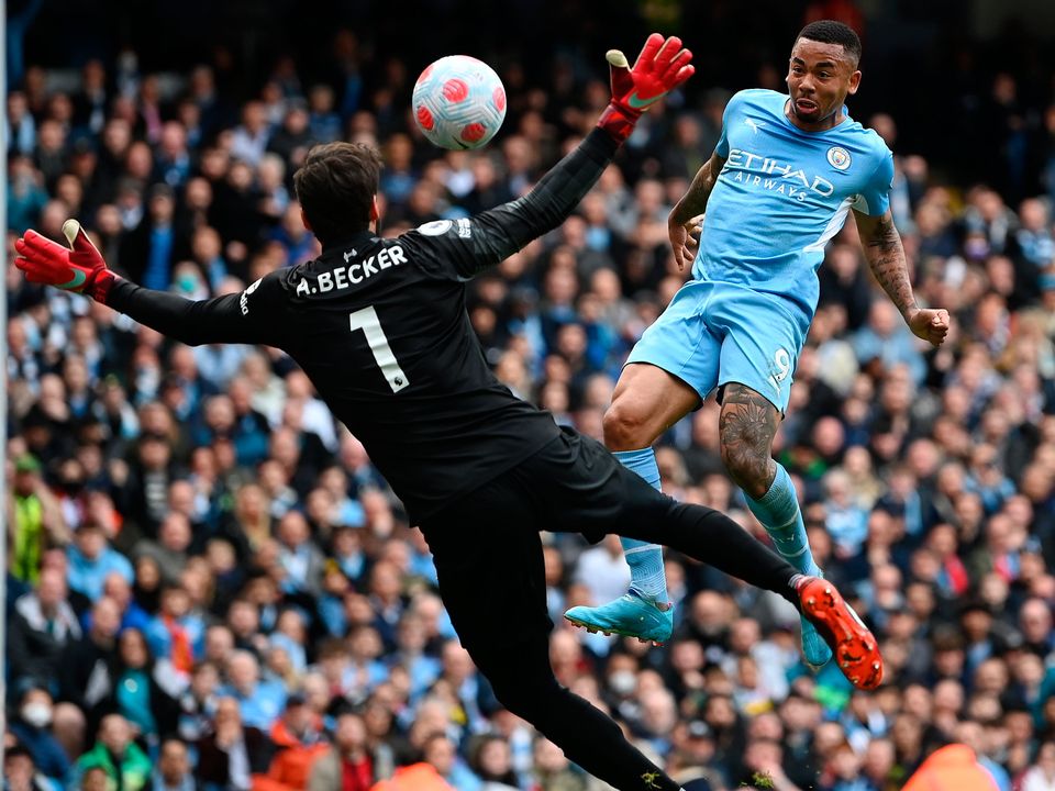 Gabriel Jesus of Manchester City scores their side's second goal past Alisson Becker of Liverpool. (Photo by Shaun Botterill/Getty Images)