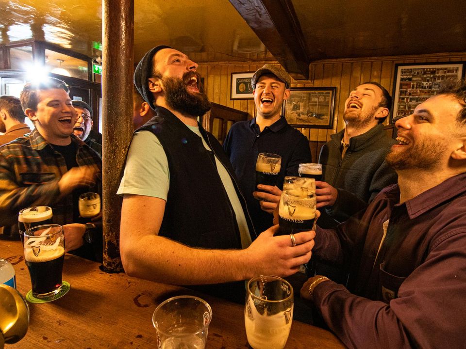 Friends enjoy a few pints at the bar of John Kavanagh's pub in Glasnevin, Dublin. Picture by Mark Condren