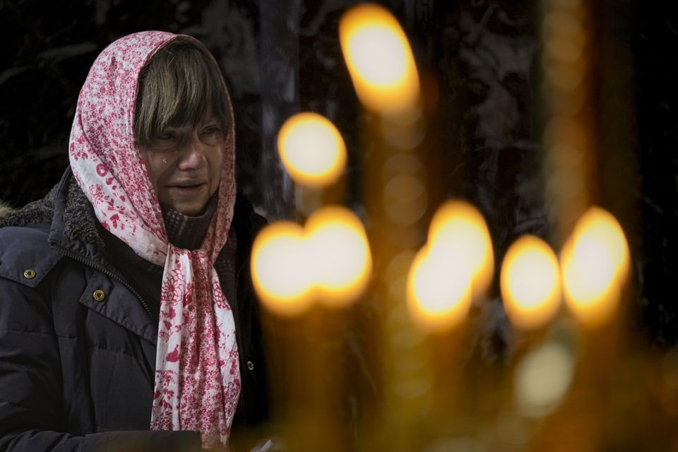 A woman cries during a religious service at the St Volodymyr’s Cathedral in Kyiv on Sunday (Vadim Ghirda/AP)