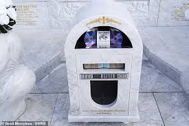 The memorial features a the solar-powered jukebox playing the late father-of-nine's favourite tracks.