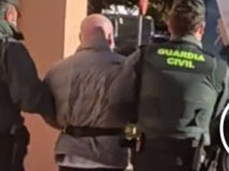 Irishman Mark 'Baldy' Byrne is led away by Spanish authorities