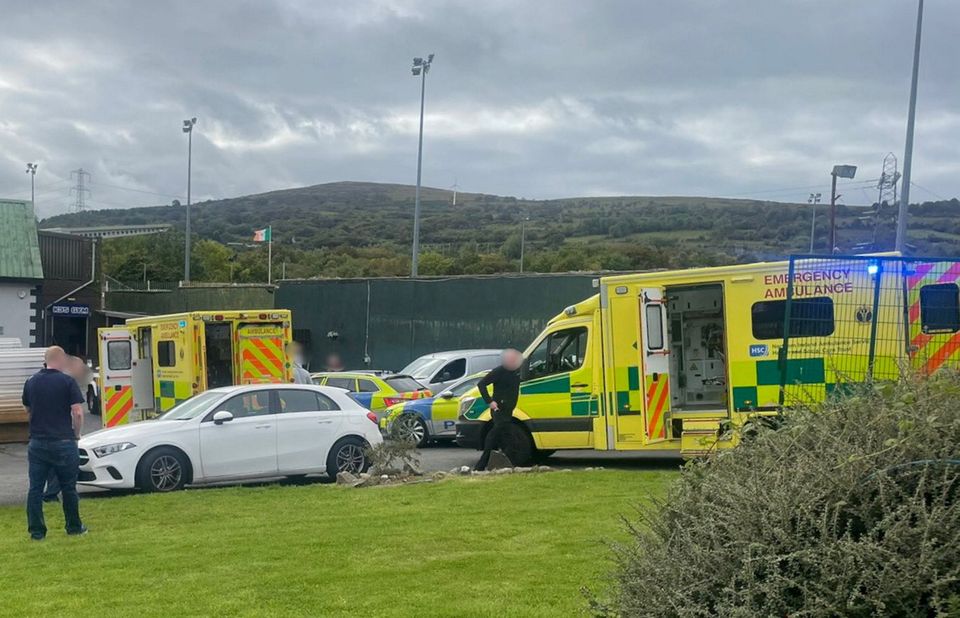 Police and paramedics at the scene of a shooting incident at the Donegal Celtic FC in west Belfast