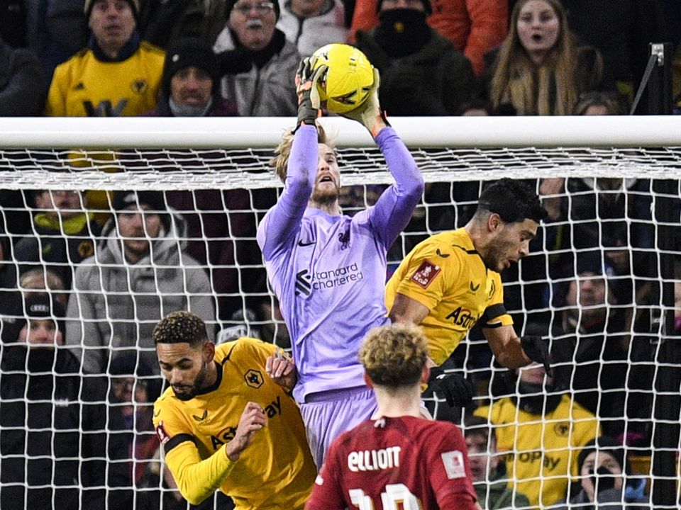 Liverpool's Irish goalkeeper Caoimhin Kelleher (rear C) catches the ball during the FA Cup third round football match between Wolverhampton Wanderers and Liverpool FC at the Molineux stadium in Wolverhampton, central England on January 17, 2023. - - RESTRICTED TO EDITORIAL USE. No use with unauthorized audio, video, data, fixture lists, club/league logos or 'live' services. Online in-match use limited to 120 images. An additional 40 images may be used in extra time. No video emulation. Social media in-match use limited to 120 images. An additional 40 images may be used in extra time. No use in betting publications, games or single club/league/player publications. (Photo by Oli SCARFF / AFP) / RESTRICTED TO EDITORIAL USE. No use with unauthorized audio, video, data, fixture lists, club/league logos or 'live' services. Online in-match use limited to 120 images. An additional 40 images may be used in extra time. No video emulation. Social media in-match use limited to 120 images. An additional 40 images may be used in extra time. No use in betting publications, games or single club/league/player publications. / RESTRICTED TO EDITORIAL USE. No use with unauthorized audio, video, data, fixture lists, club/league logos or 'live' services. Online in-match use limited to 120 images. An additional 40 images may be used in extra time. No video emulation. Social media in-match use limited to 120 images. An additional 40 images may be used in extra time. No use in betting publications, games or single club/league/player publications. (Photo by OLI SCARFF/AFP via Getty Images)