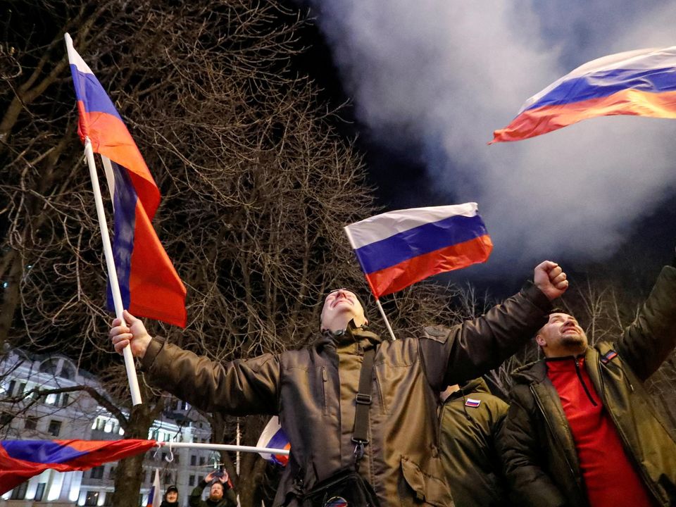 Pro-Russian activists react on a street after Russian President Vladimir Putin signed a decree recognising two Russian-backed breakaway regions in eastern Ukraine as independent entities. Photo: Alexander Ermochenko