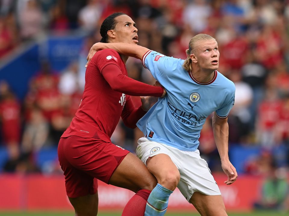 Virgil van Dijk of Liverpool and Erling Haaland of Manchester City grapple for a high ball. (Photo by Michael Regan - The FA/The FA via Getty Images)