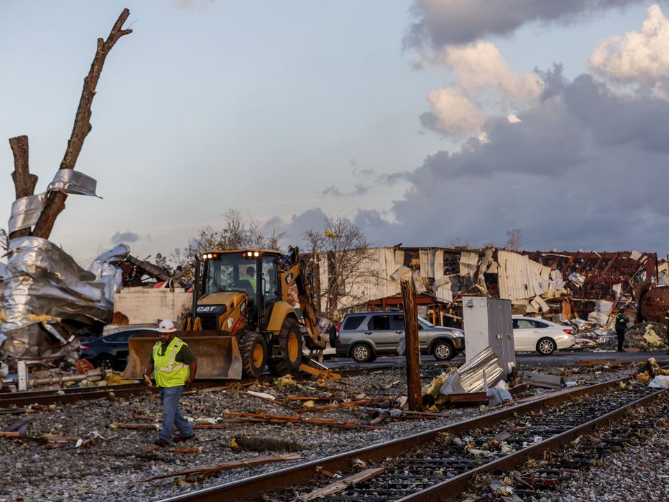 Workers remove debris from railroad tracks after a tornado passed through downtown Selma, Thursday, Jan. 12, 2023, in Selma Ala.. (AP Photo/Butch Dill)