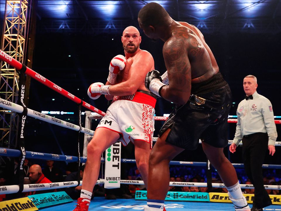 Tyson Fury punches Dillian Whyte during the WBC World heavyweight fight