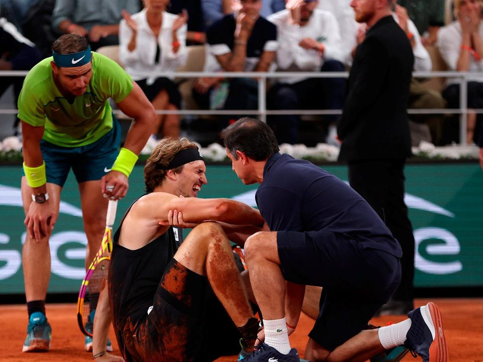 Alexander Zverev of Germany receives medical attention following an injury against Rafael Nadal of Spain during the Men's Singles semi-final at Roland Garros. Photo by Clive Brunskill/Getty Images