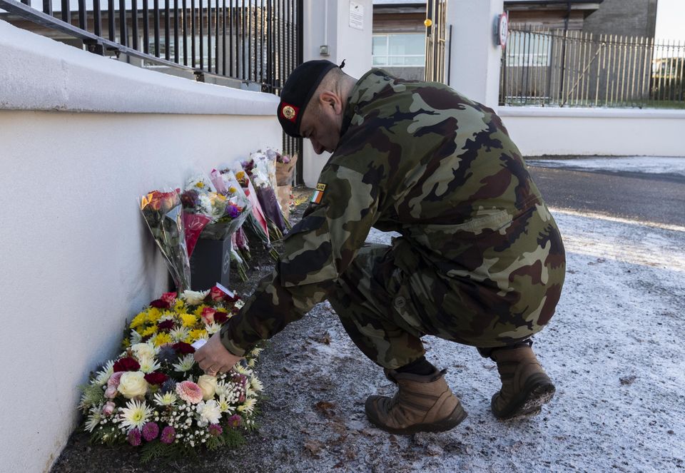 An Army comrade of Pte Sean Rooney’s reads messages left to mark the death of the soldier, killed while travelling in a UN car