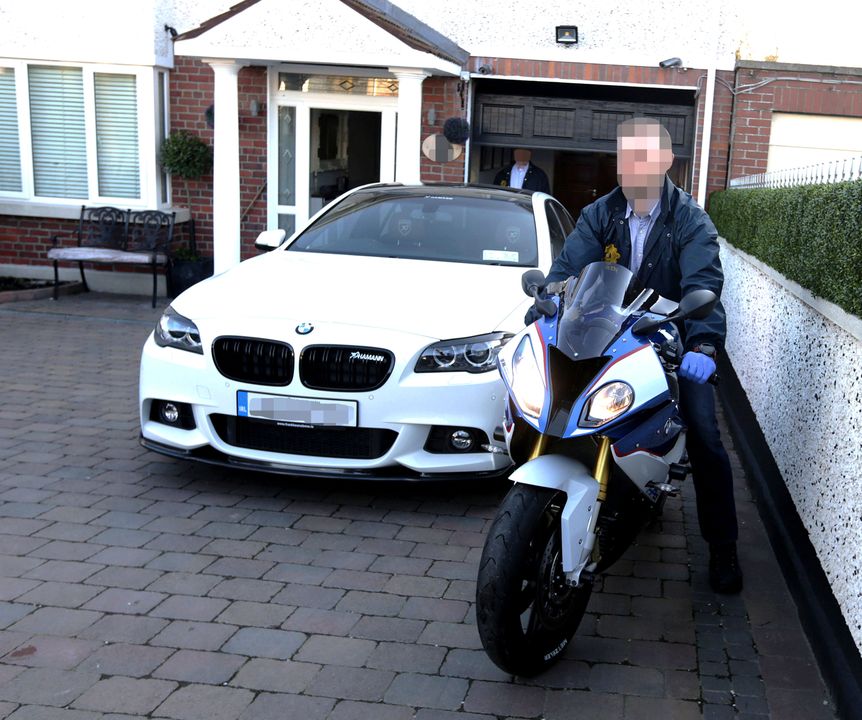 Garda remove a BMW car and motorcycle from the home of Jonathan Dowdall on the Navan Road. Picture credit; Damien Eagers 10/3/2016