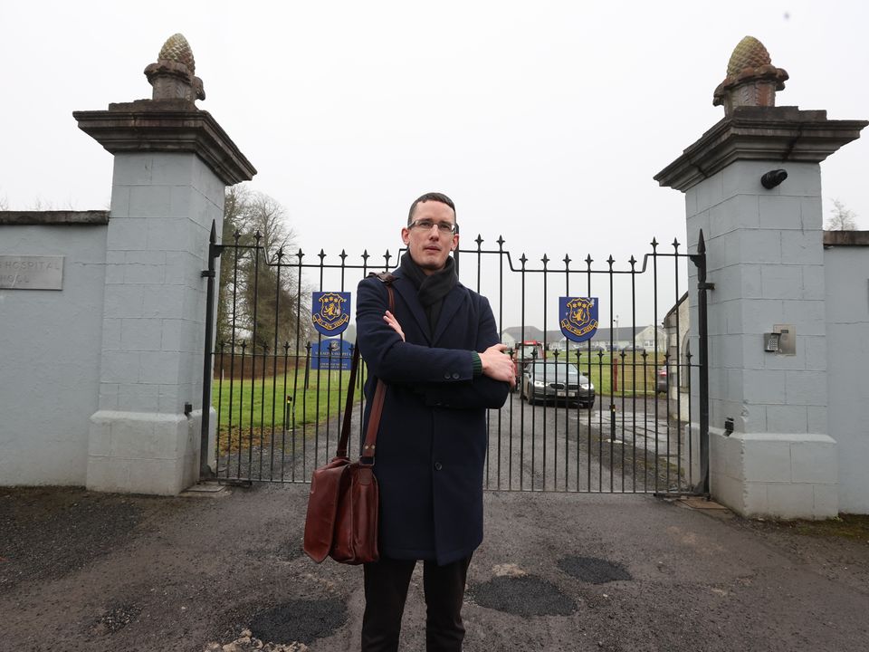 Dismissed teacher Enoch Burke outside the locked gates of Wilson's Hospital School in Westmeath. Photo: Gerry Mooney