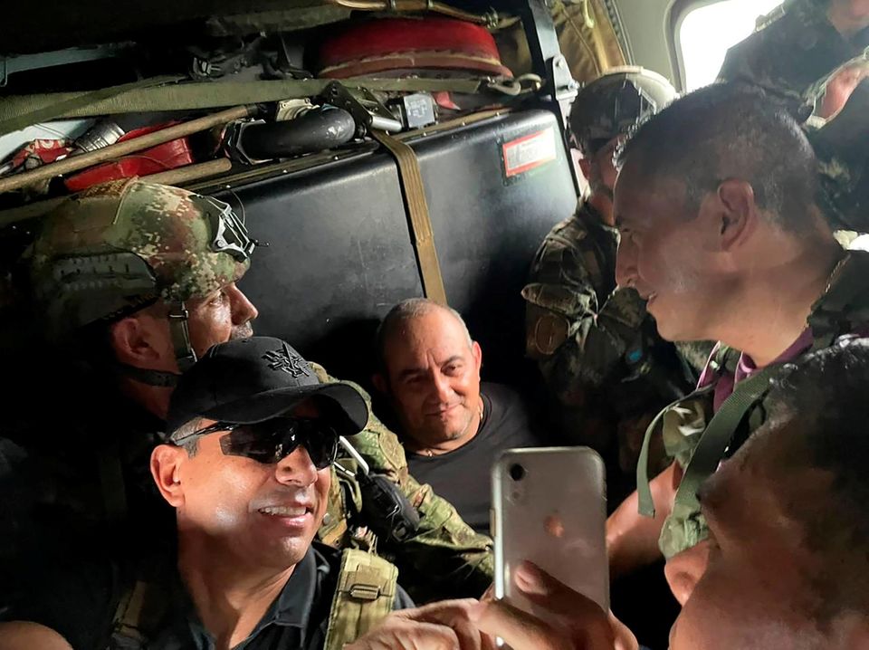 Dairo Antonio Usuga David, alias "Otoniel", top leader of the Gulf clan, poses for a photo while escorted by Colombian military soldiers inside a helicopter after being captured, in Turbo, Colombia.