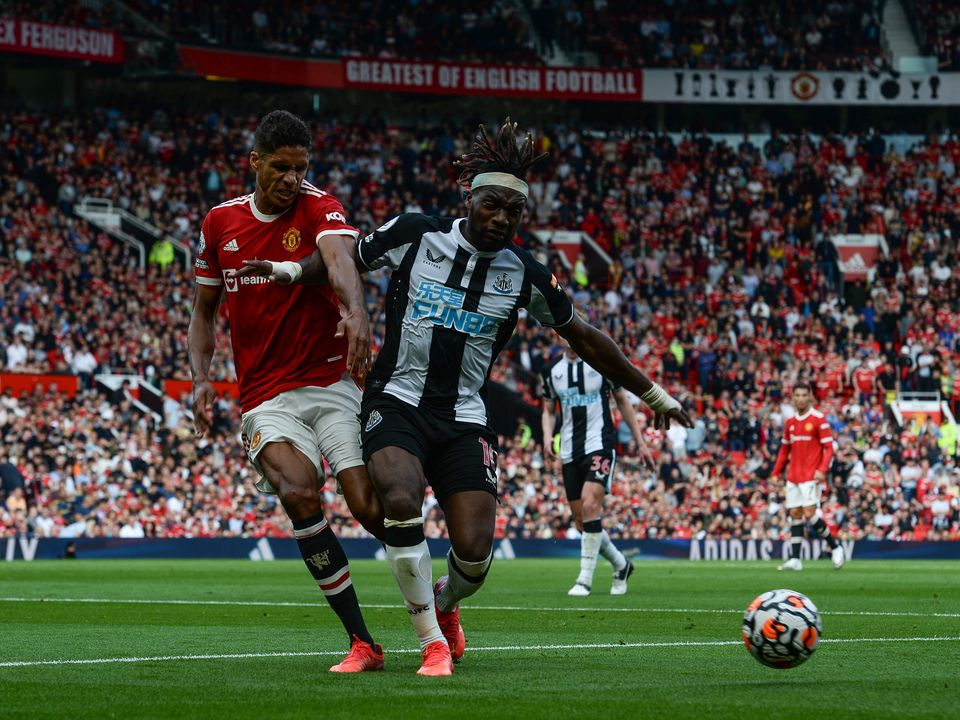 Allan Saint-Maximin of Newcastle United  and Raphael Varane of Manchester United (19) jostle for the ball. Photo: Serena Taylor/Newcastle United via Getty Images
