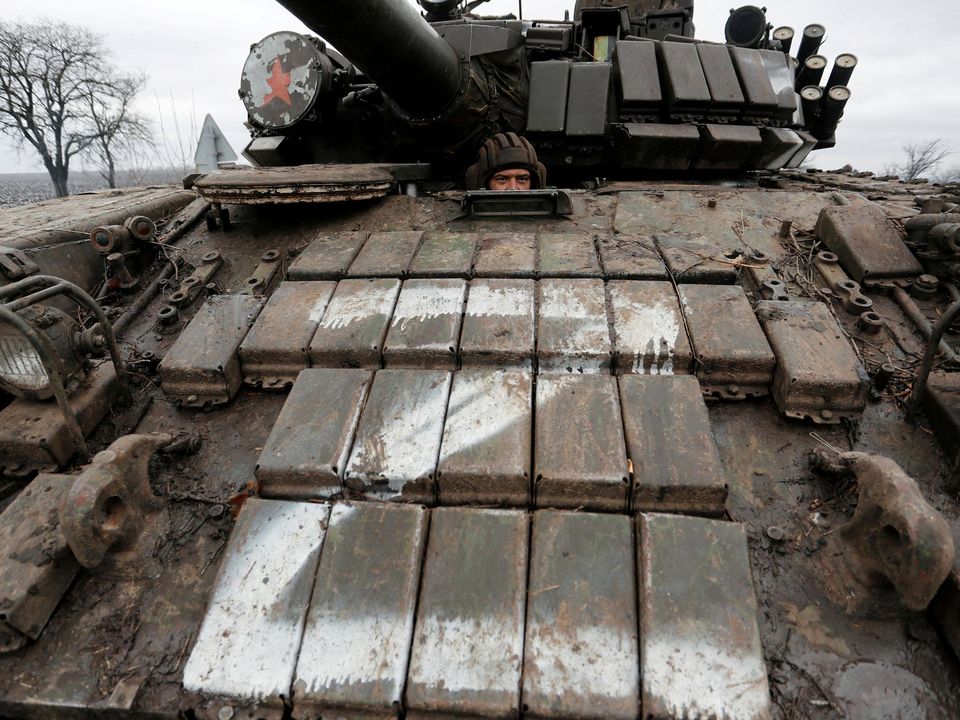 A serviceman of pro-Russian militia is seen inside a tank of armed forces of the separatist self-proclaimed Luhansk People's Republic (LNR) on a road in the Luhansk region, Ukraine February 27, 2022. Photo: Reuters/Alexander Ermochenko