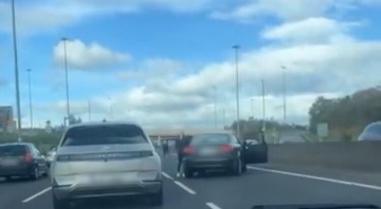A man can be seen getting out of a car