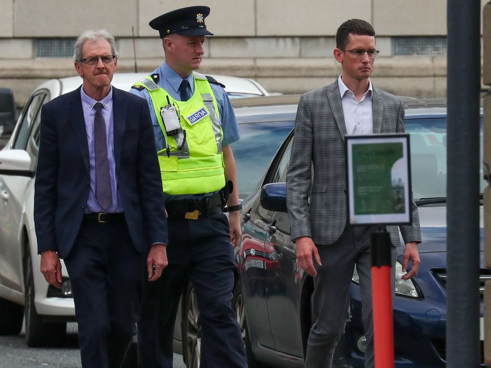 Enoch Burke (R), being brought into the Four Courts by Gardaí, accompanied by his father, Sean Burke (L). PIC: Collins Courts