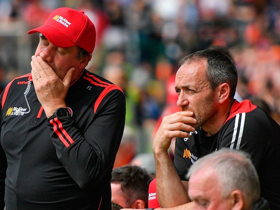 Tyrone managers Feargal Logan (left) and Brian Dooher watch their team's defeat to Armagh. Photo: Ramsey Cardy/Sportsfile