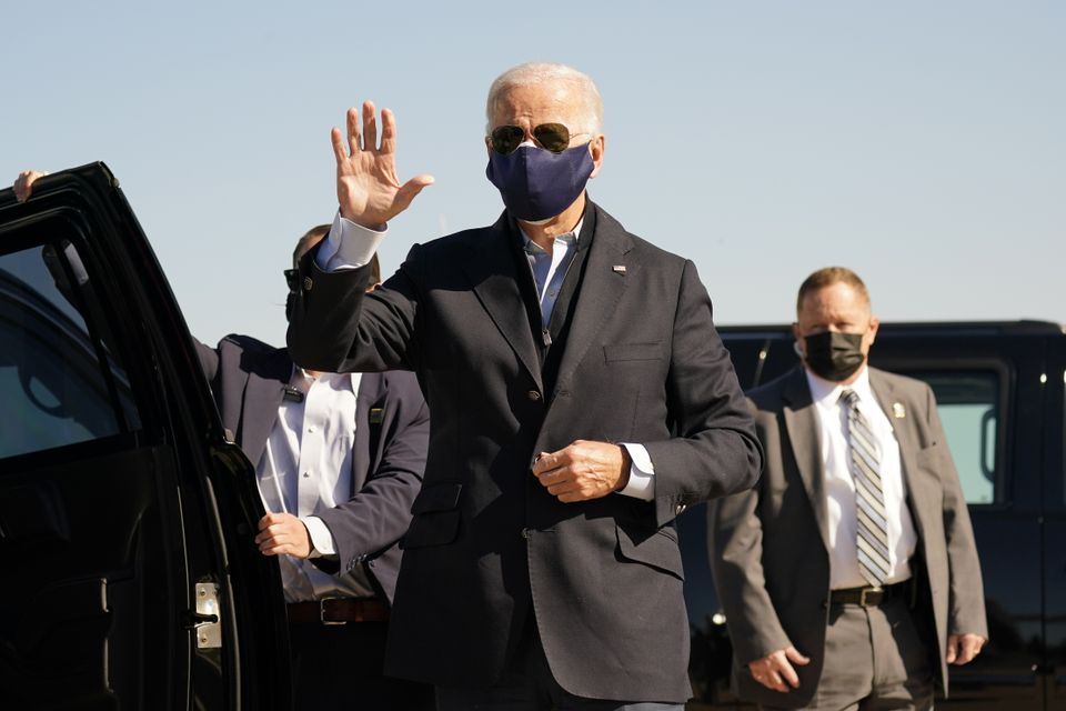 Joe Biden arrives to board his campaign plane in Delaware (Carolyn Kaster/AP)