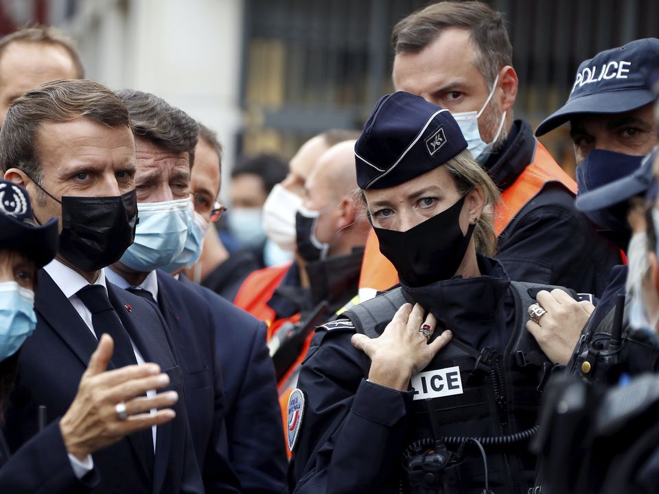 French President Emmanuel Macron, second left, meets police officers in Nice (Eric Gaillard/Pool via AP)
