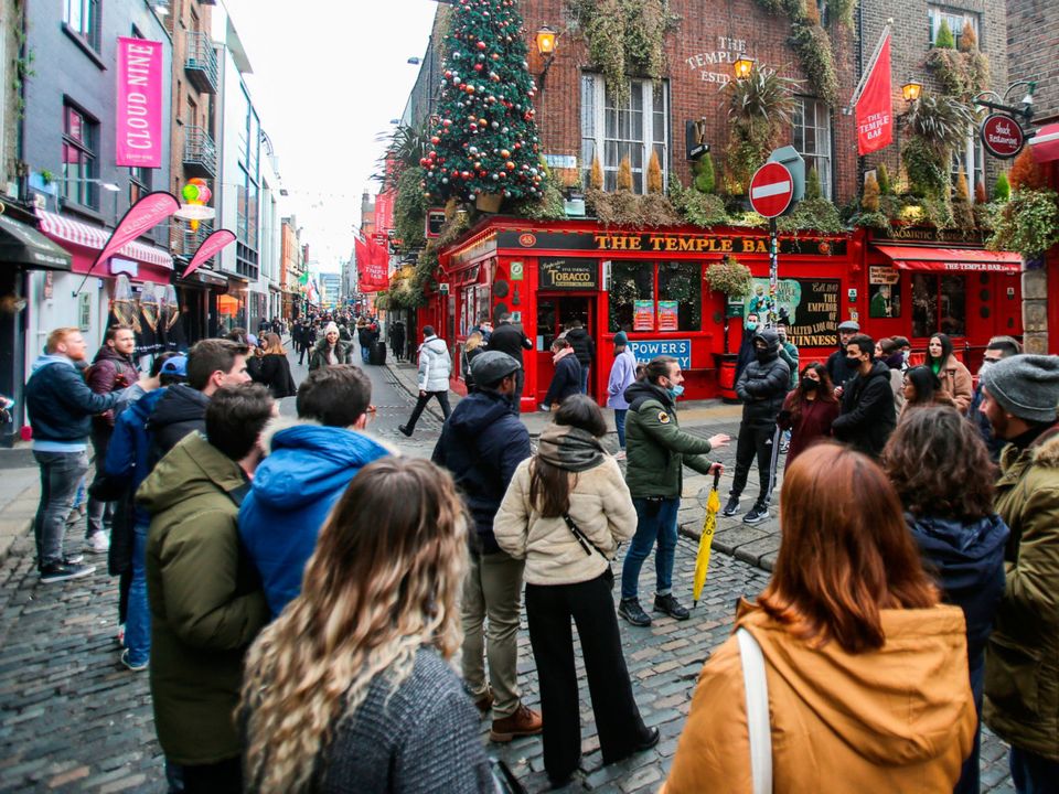 A tour group stops at the Temple Bar in Dublin