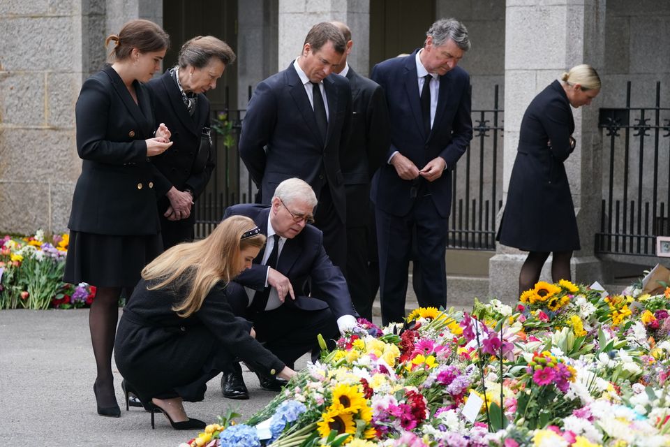 (Left-right back) Princess Eugenie, the Princess Royal, Peter Phillips, Sir Timothy Laurence, Zara Tindall (left-right front) Princess Beatrice and the Duke of York view the messages and floral tributes left by members of the public at Balmoral in Scotland following the death of Queen Elizabeth II on Thursday.