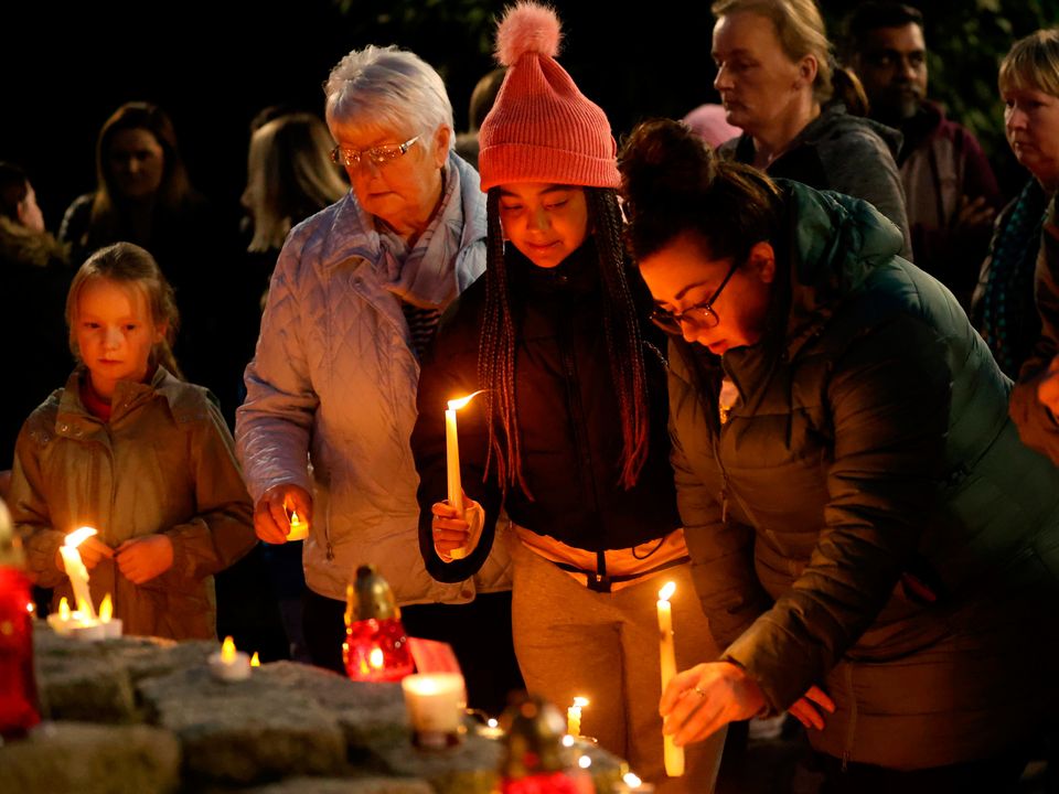 People attend a vigil at Market Square, Letterkenny, for the victims of the Creeslough explosion. PA