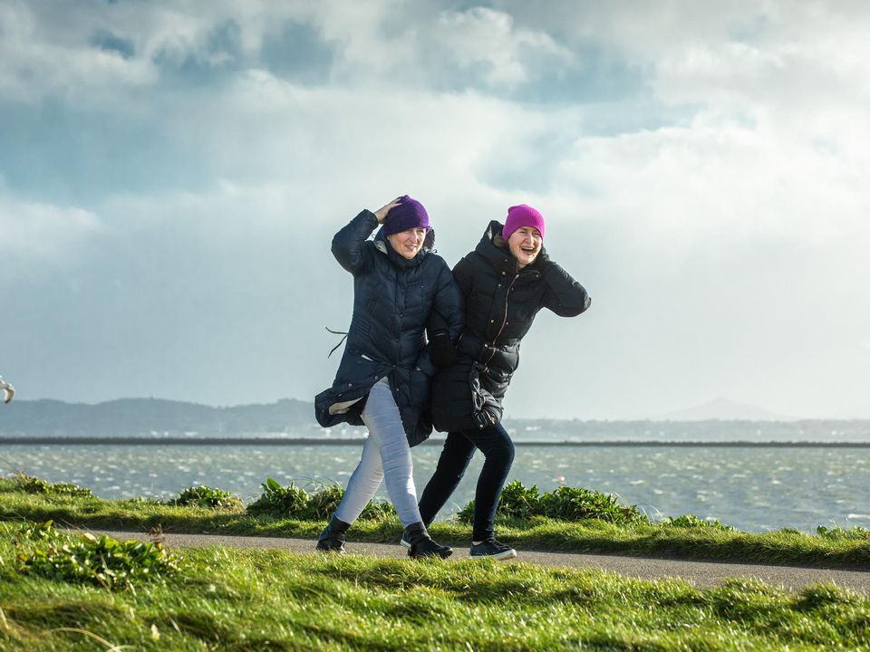 Cathy Mulcahy-Costelloe and Marianna Stockwell braving the high winds in Clontarf, Dublin, yesterday. Photo: Mark Condren
